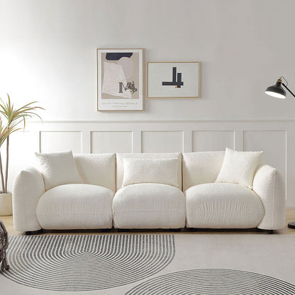 Canapé sectionnel blanc rembourré et confortable en duvet d'agneau doux avec pouf