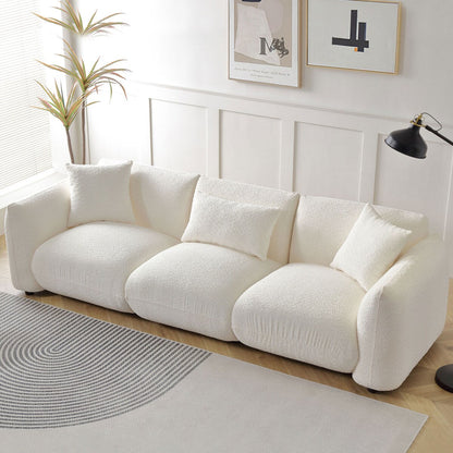 Canapé sectionnel blanc rembourré et confortable en duvet d'agneau doux avec pouf