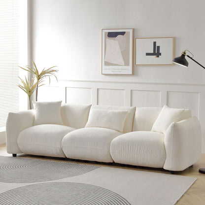 Canapé sectionnel blanc rembourré et confortable en duvet d'agneau doux avec pouf