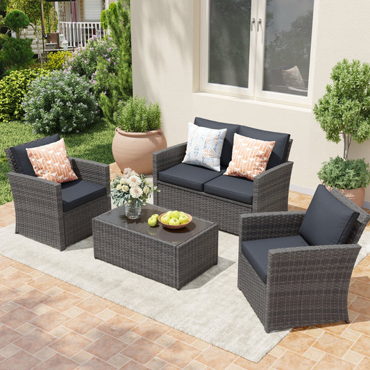 Salon de jardin en rotin pour 4 personnes avec coussins gris et table en verre trempé