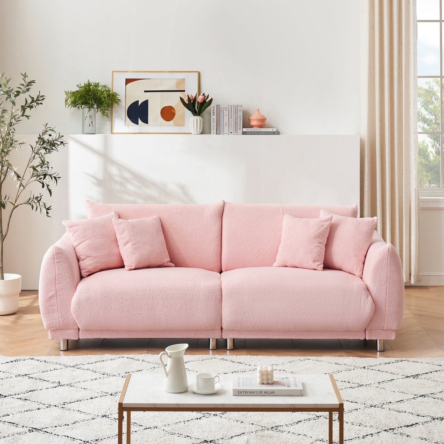 Un canapé rose en polaire de 86,6 pouces avec quatre coussins et des pieds en quincaillerie peut s'asseoir confortablement dans une chambre d'appartement
