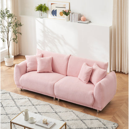 Un canapé rose en polaire de 86,6 pouces avec quatre coussins et des pieds en quincaillerie peut s'asseoir confortablement dans une chambre d'appartement