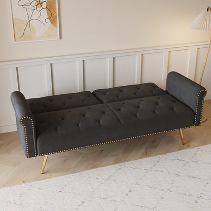 Un canapé-lit de 176 cm de long recouvert de velours, orné d'une bordure cloutée et accompagné d'un coussin assorti.