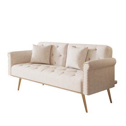 Un canapé-lit de 176 cm de long recouvert de velours, orné d'une bordure cloutée et accompagné d'un coussin assorti.