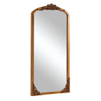 Miroir de sol sculpté en bois massif de forme arquée sur toute la longueur