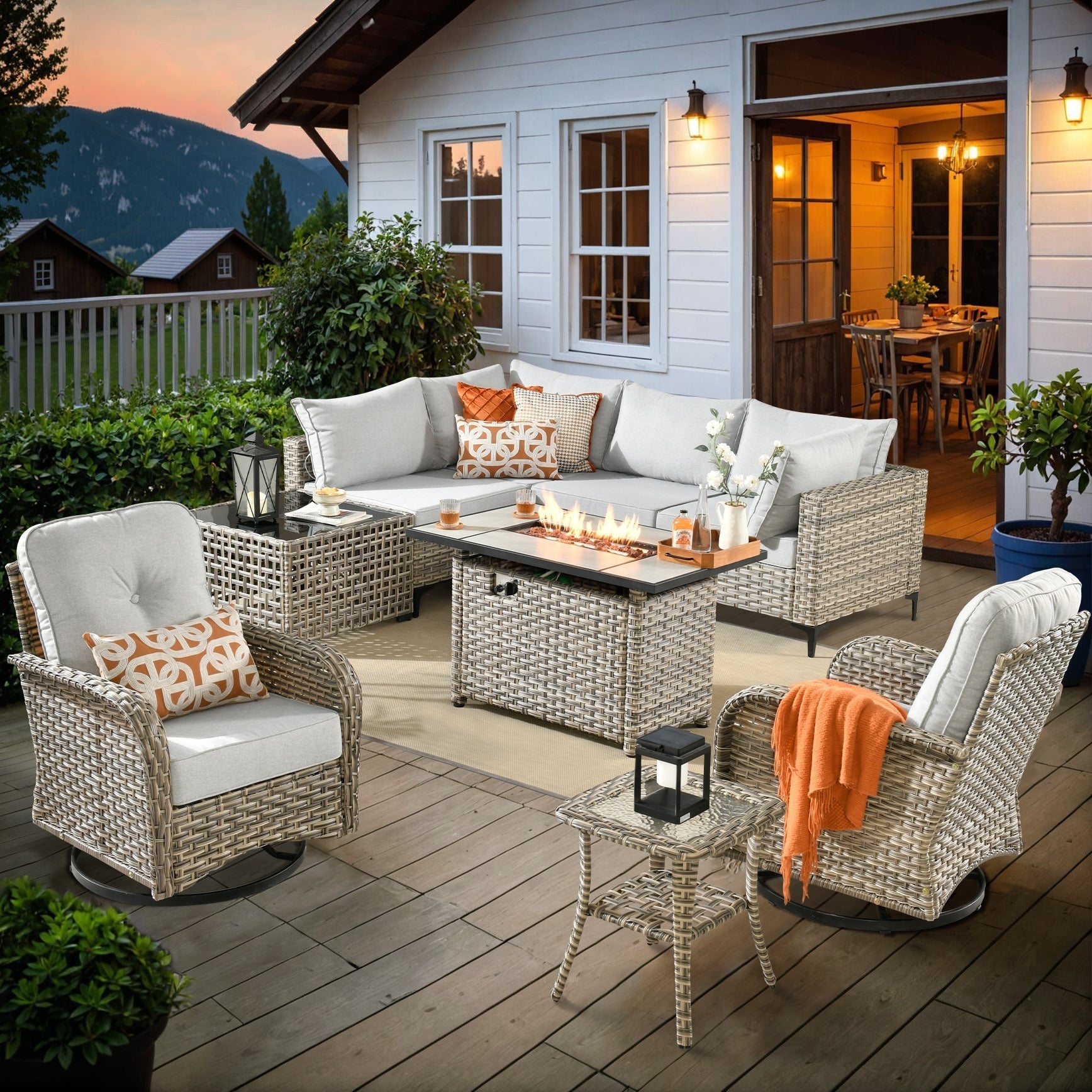 Ensemble de 9 chaises pivotantes d'extérieur en osier OVIOS avec table à feu